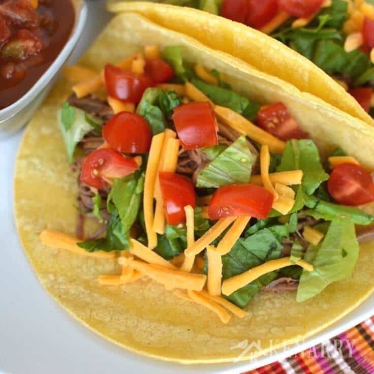 With only 4 ingredients, this shredded beef recipe for easy slow cooker tacos couldn't be easier. Just add your favorite toppings for a delicious weeknight dinner!