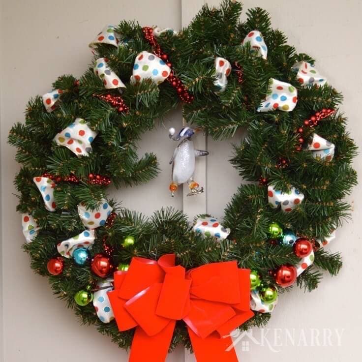 Love this idea to decorate an outdoor Christmas wreath with ribbon, beads and ornaments. Beautiful holiday home decor for your front door! - Kenarry.com