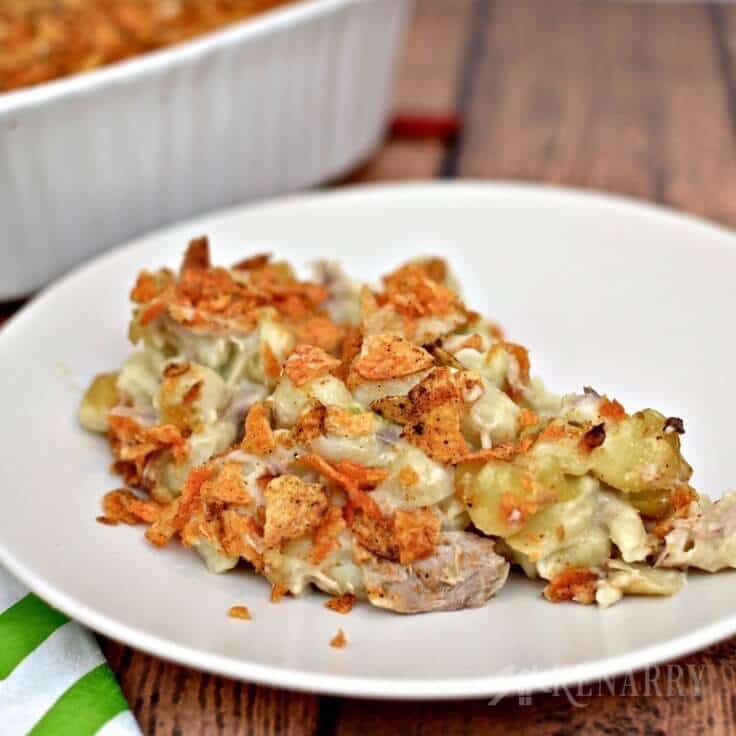 This Cheesy Tuna Casserole recipe is easy to make with shell pasta and topped with crushed barbecue chips. It's a delicious idea for a weeknight meal.