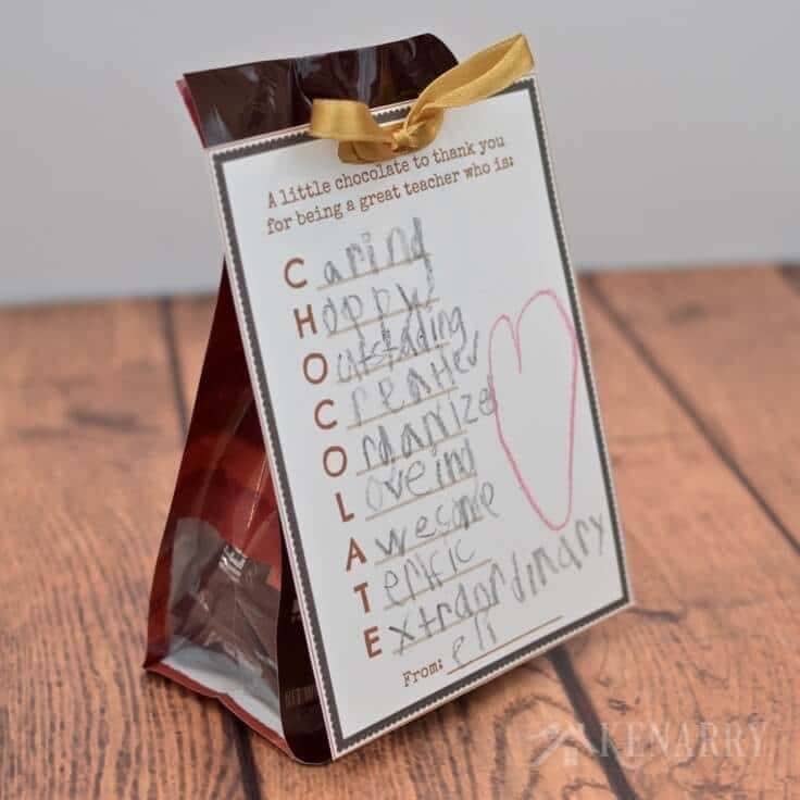 A bag of candy with a tag tied to the front with an acrostic for the word chocolate filled in by a child for a free teacher appreciation printable.
