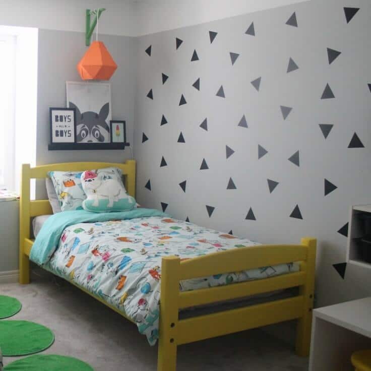 A boy's bedroom with triangles painted on the wall