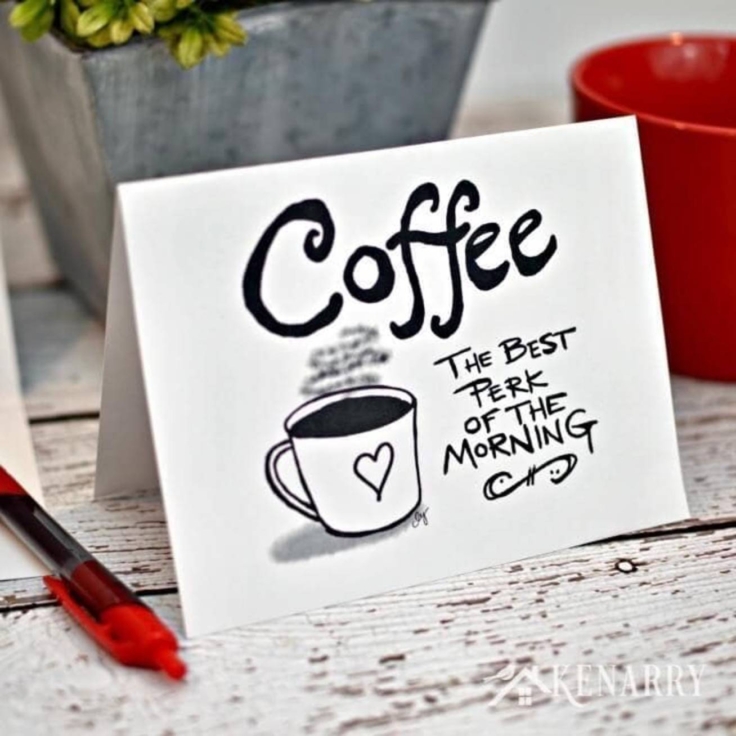 White folded card with a mug of coffee drawing and text that reads "coffee: the best perk of the morning."