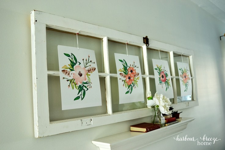 Wall art made from an old window and flower prints.