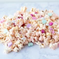 Cupid Popcorn will be a big hit with kids at the school class Valentine's Day party. This easy Valentine's Day recipe is fun and festive with conversation hearts and valentine M&Ms.