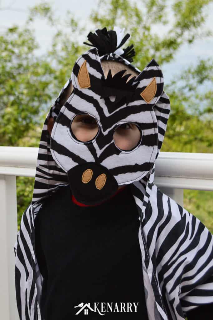 Use this tutorial with free printable diy mask template to make an easy kids zebra costume for your child to wear for jungle animal dress-up or a cute Halloween costume idea.