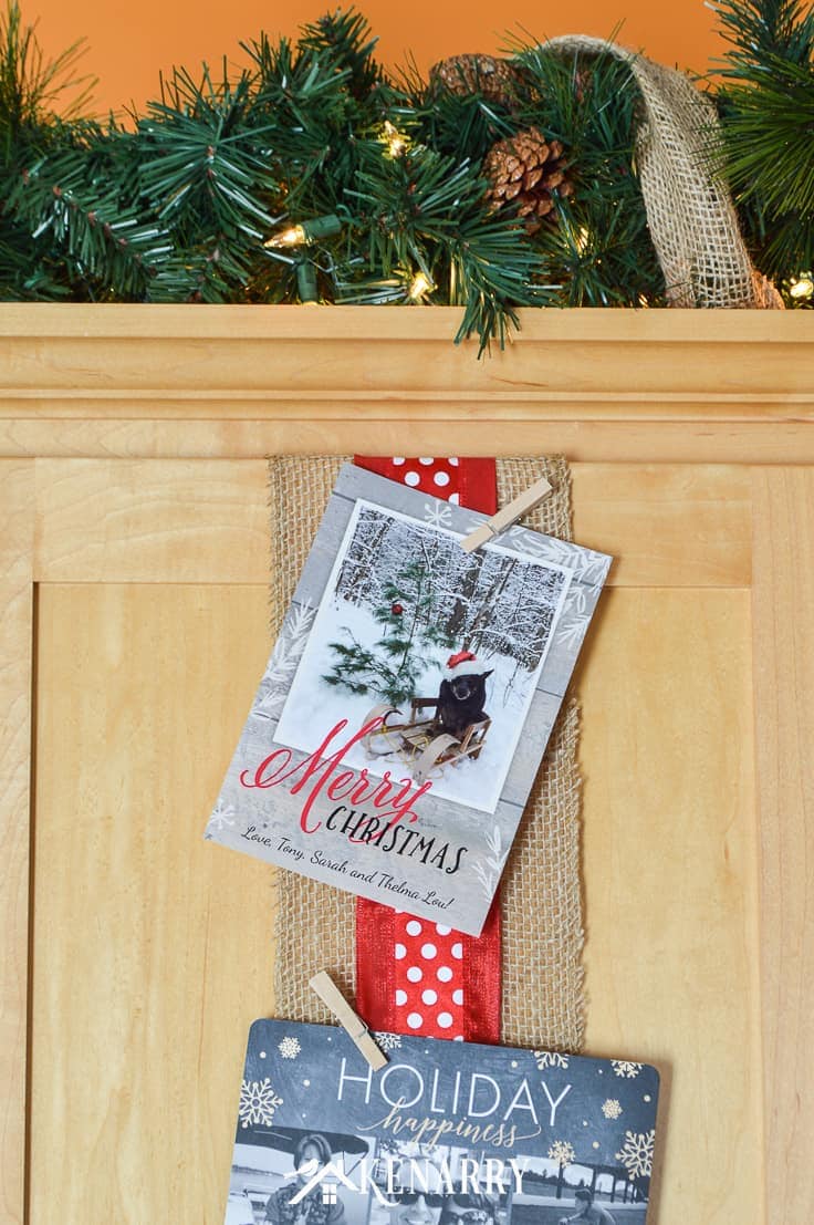 Use wide ribbon, burlap and small clothes pins for displaying Christmas cards on your kitchen cabinets so you can enjoy looking at them throughout the holidays.