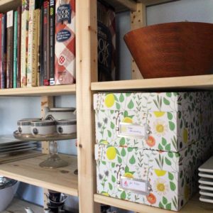 Using open shelving can be pretty and practical for kitchen organizing. All you need are a few photo boxes and some printable labels to not only hide the clutter but make it easy to find when you need it.