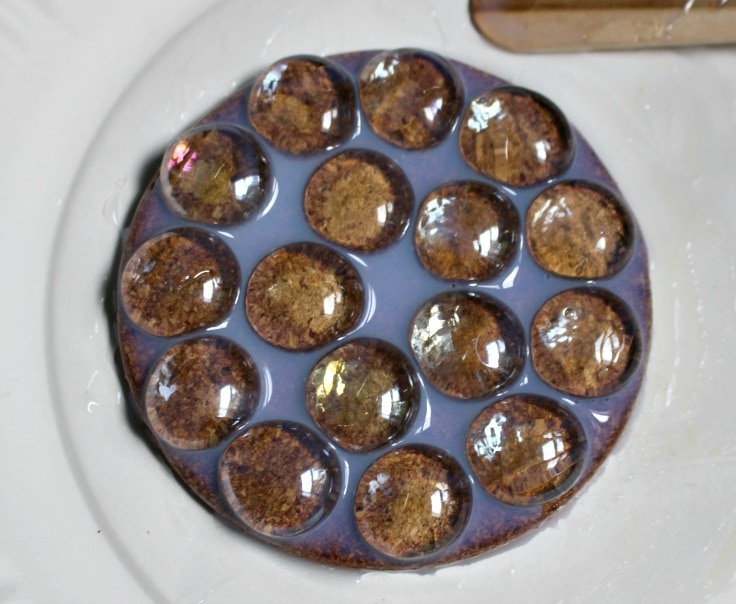 What it looks like after adding triple thick glaze on cork coasters with glass gems glued on. 