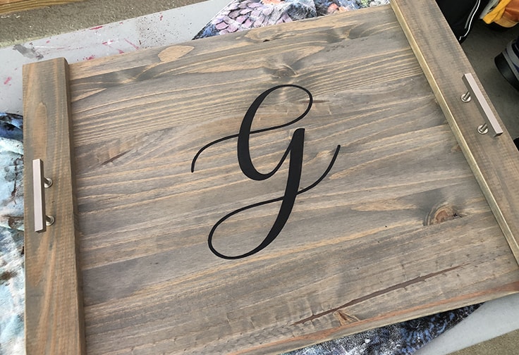 Monogrammed wood stovetop cover with letter G.