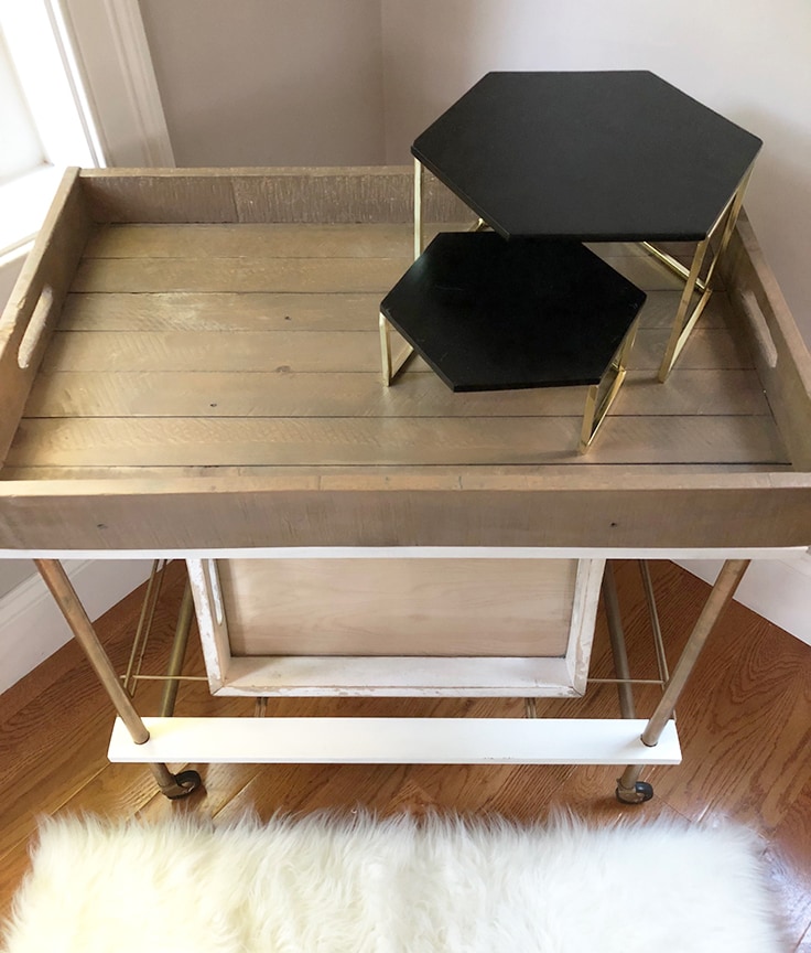 An empty bar cart with a few shelves to give it different levels