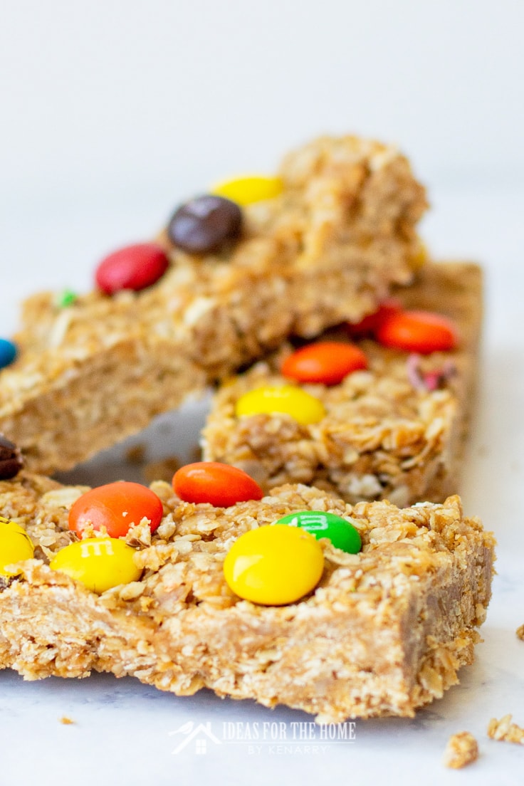 Close up of oatmeal and peanut butter granola bars topped with colorful M&M candies
