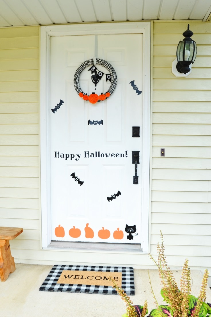 DIY Halloween door decorations on a white front door of a house