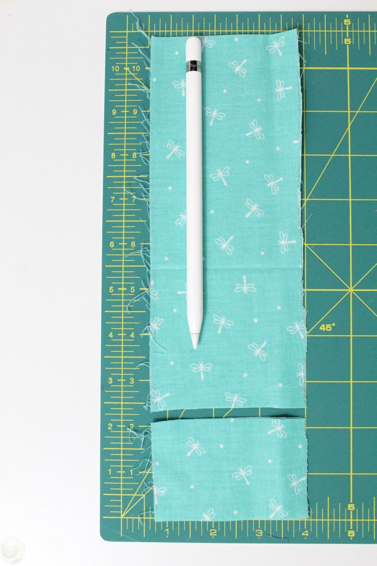 An Apple Pencil sitting on a small scrap of fabric
