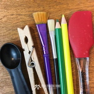 Paint brushes, colored pencils, a spatula, teaspoon and clothespin used by the Kenarry Creative Team to make recipes, crafts and DIY projects.