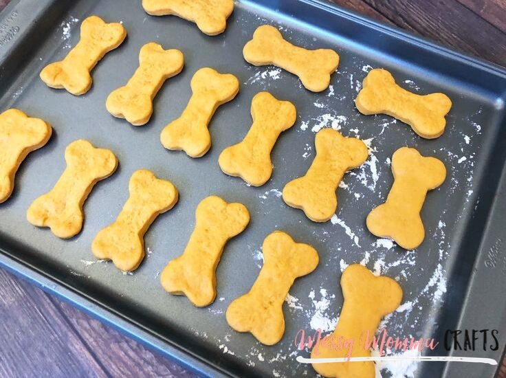 Lightly flour a baking pan, roll out the dough and cut out several dog bone shapes with the dog bone cookie cutter.