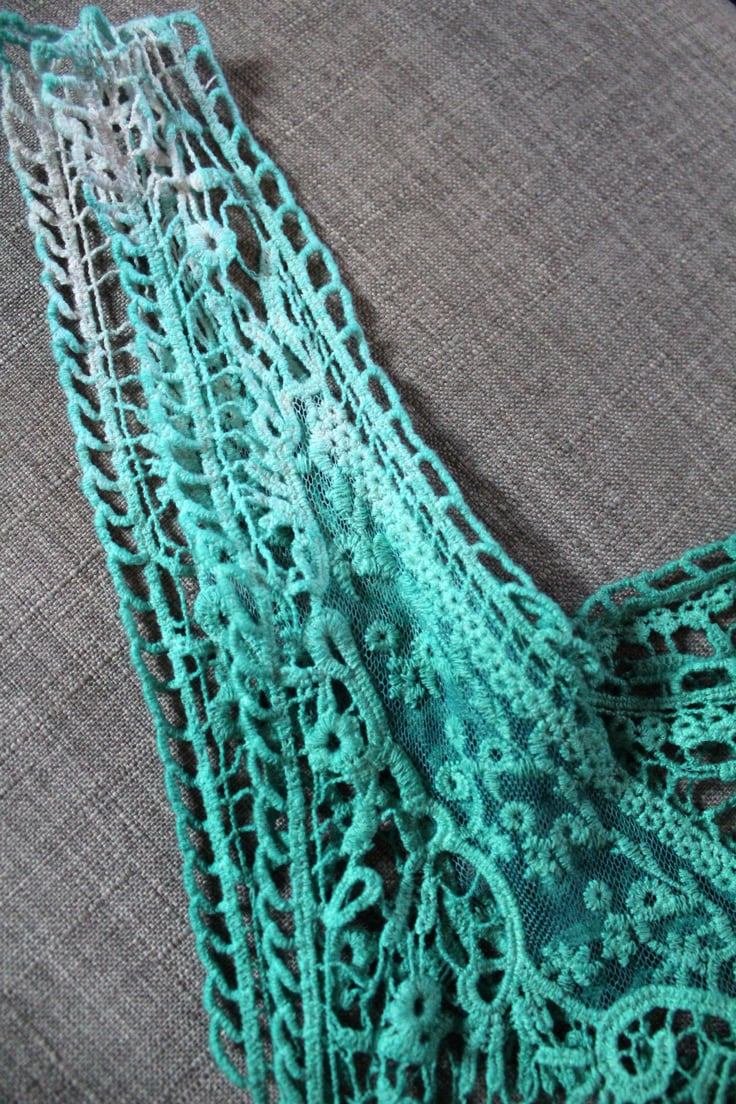 closeup of the dip dye tunic shoulder strap that fades from the original off-white to light green and then dark green