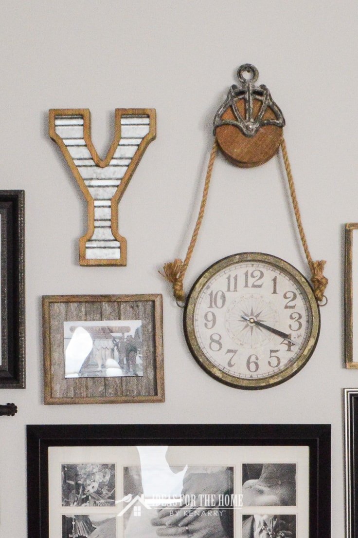 A farmhouse style clock and galvanized metal monogram Y used for home decor in a family photo gallery wall