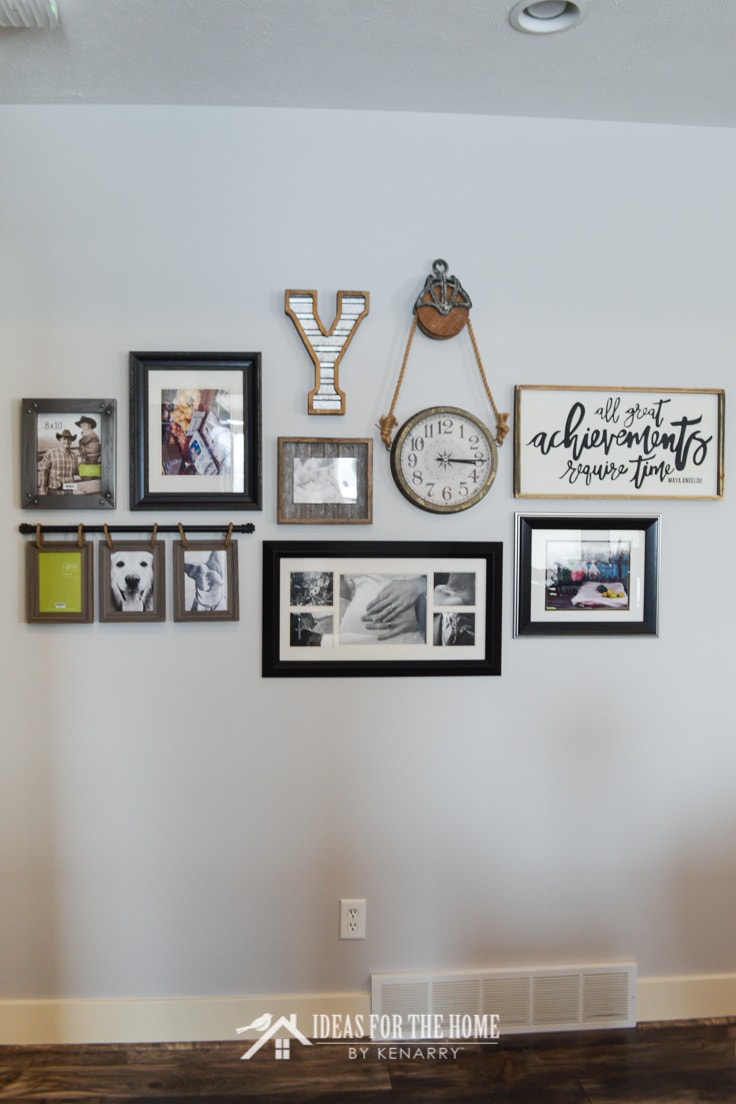 A collage of picture frames on a living room wall