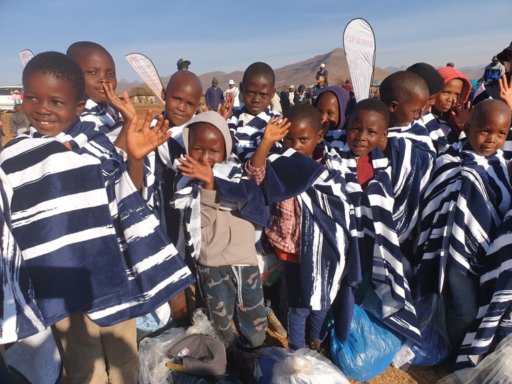 Children in Lesotho receiving towels to keep them warm to get to school through a partnership between World Vision and Thirty-One Gifts