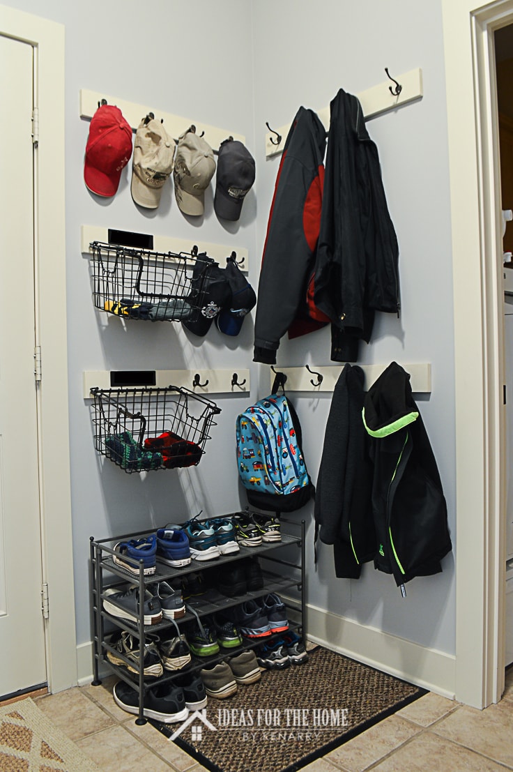 Mudroom organizing tips include having plenty of coat hooks and a shoe rack to keep the space neat and tidy.