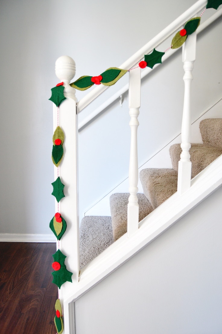 the completed felt leaf garland on the railing of the stairs