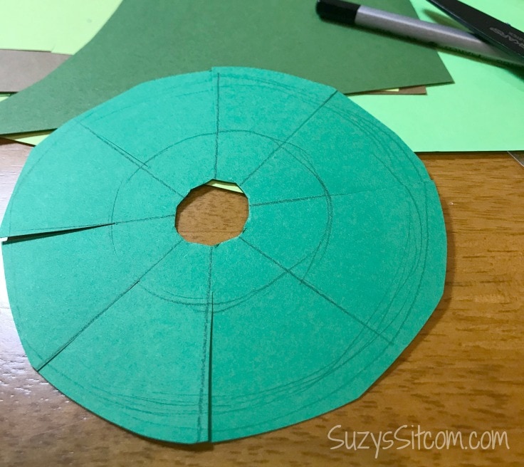 Making the smallest layer of the paper holiday tree.