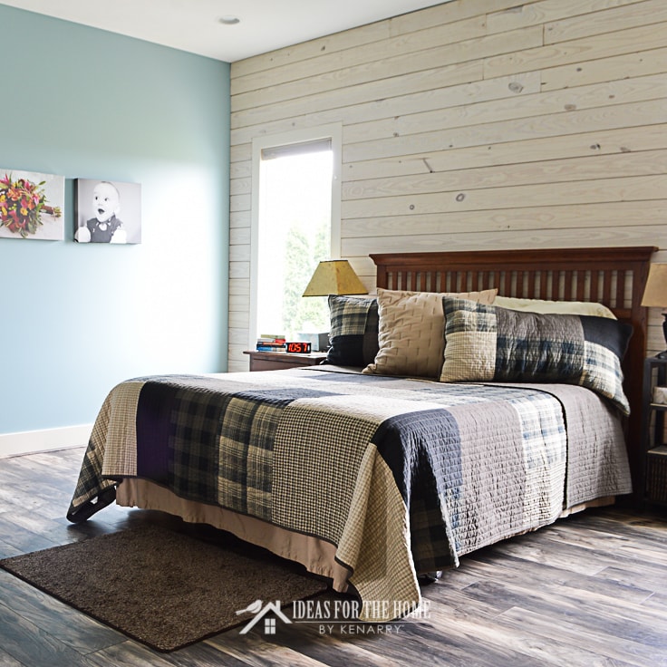 Queen sized bed with a Woolrich quilt in a master bedroom