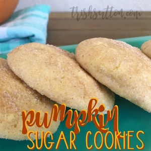 pumpkin sugar cookies on a teal platter