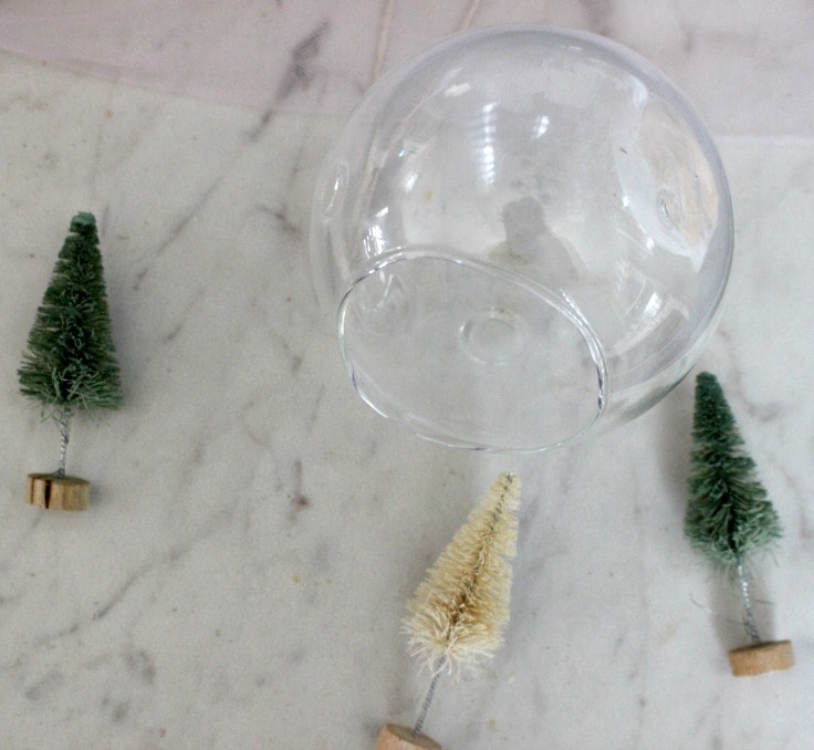 clear glass ornament with bottle brush trees