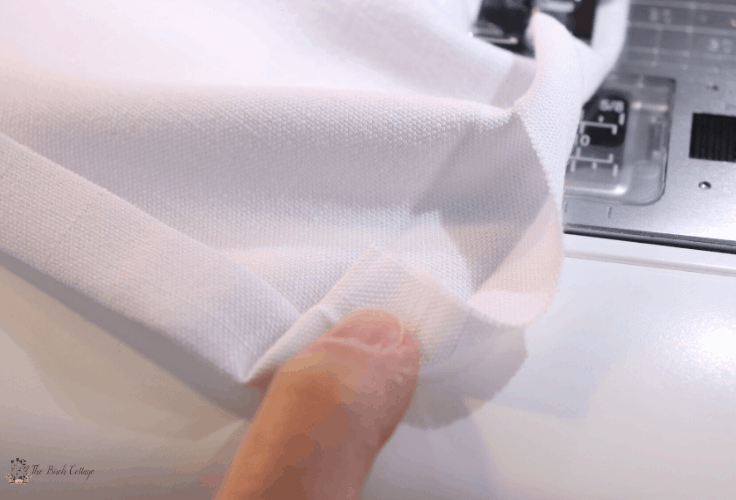 Fold the fabric at 45 degrees so the raw edge rests on the inside. 