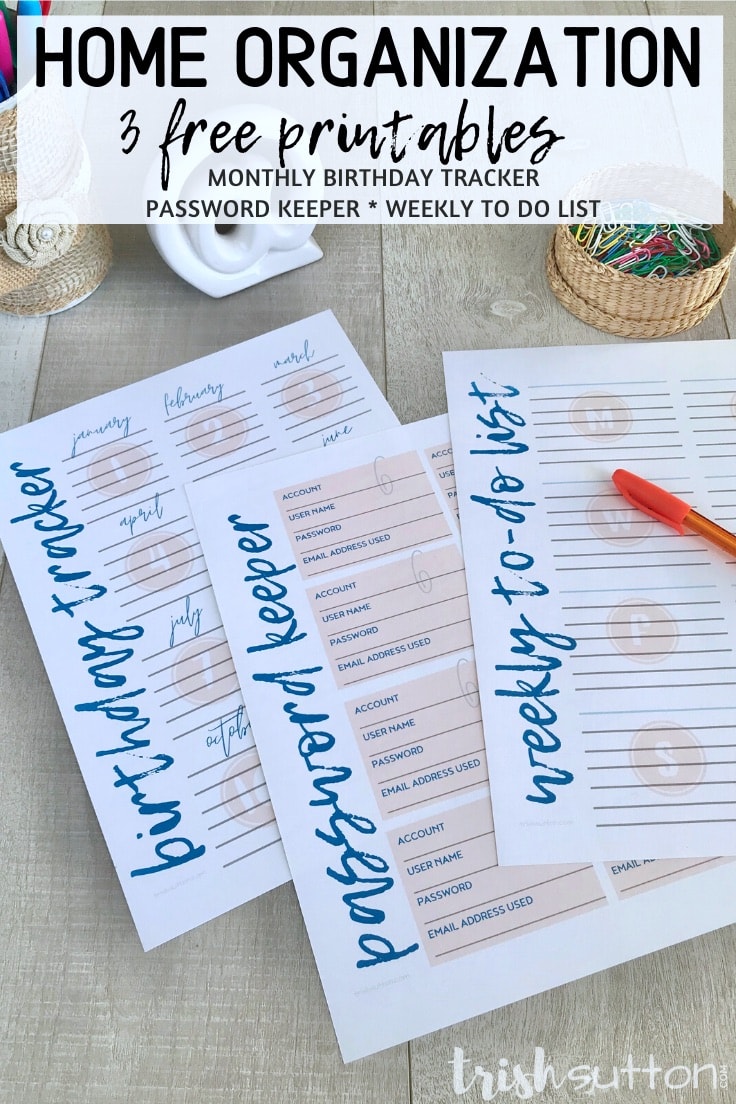 Three home organization free printables with an orange pen and paperclips on a wood background.