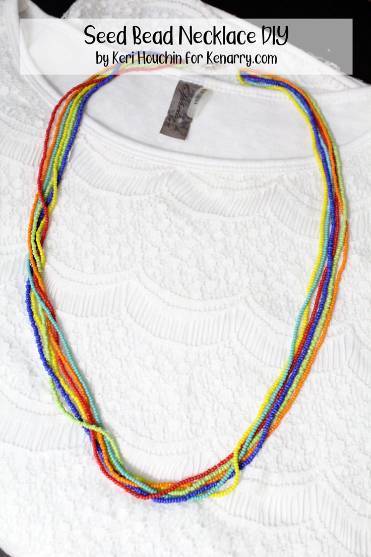 seed bead necklace with rainbow colored strands on a white dress