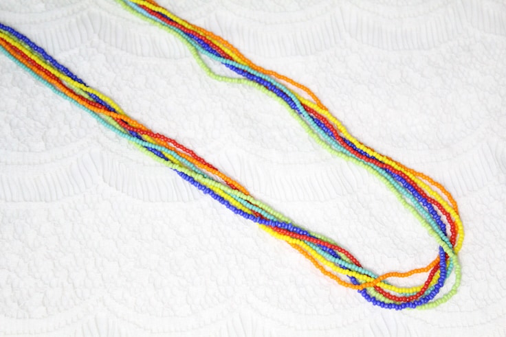 rainbow seed bead necklace on a white background