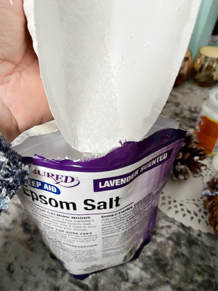 pouring epsom salt back into bag with folded paper plate