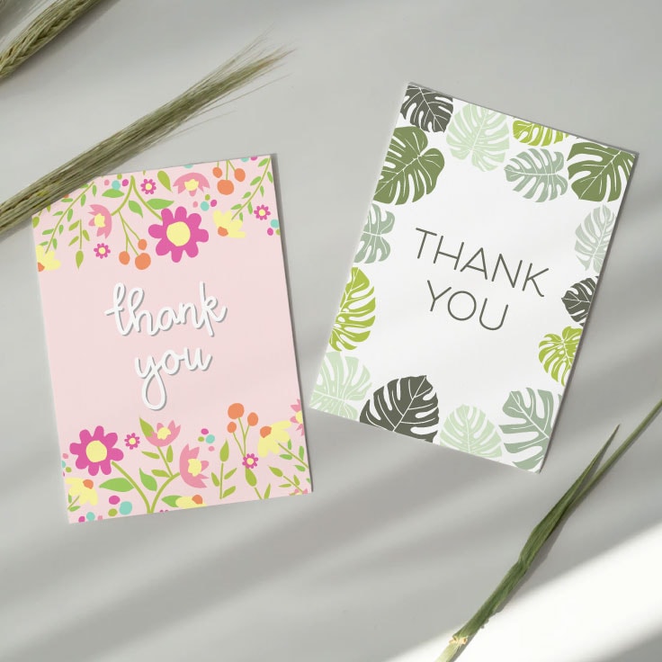 Two thank you cards with pink spring flowers and green monstera leaves.