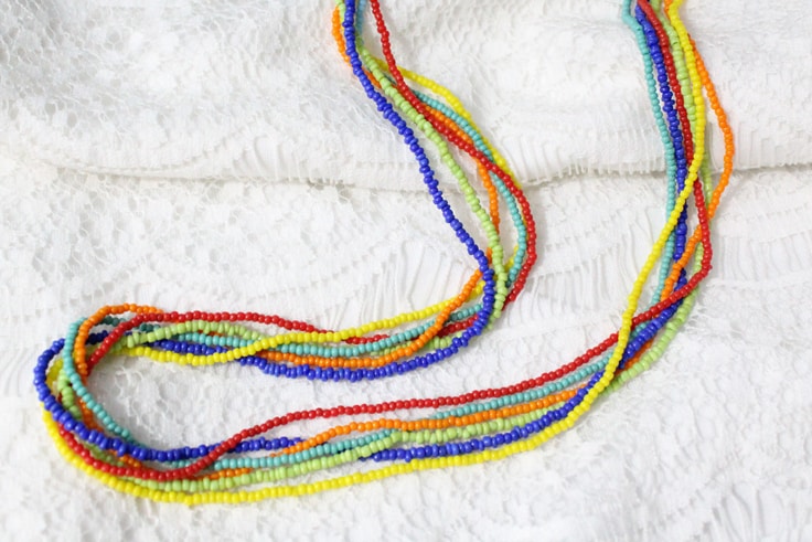 rainbow seed bead necklace on a lacy white background