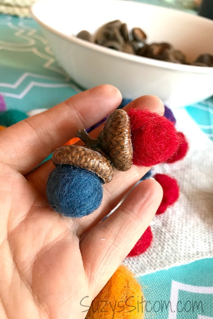Gluing the acorn caps to the wool felt balls