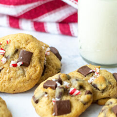 Close up of chocolate chunk cookies with a glass of milk