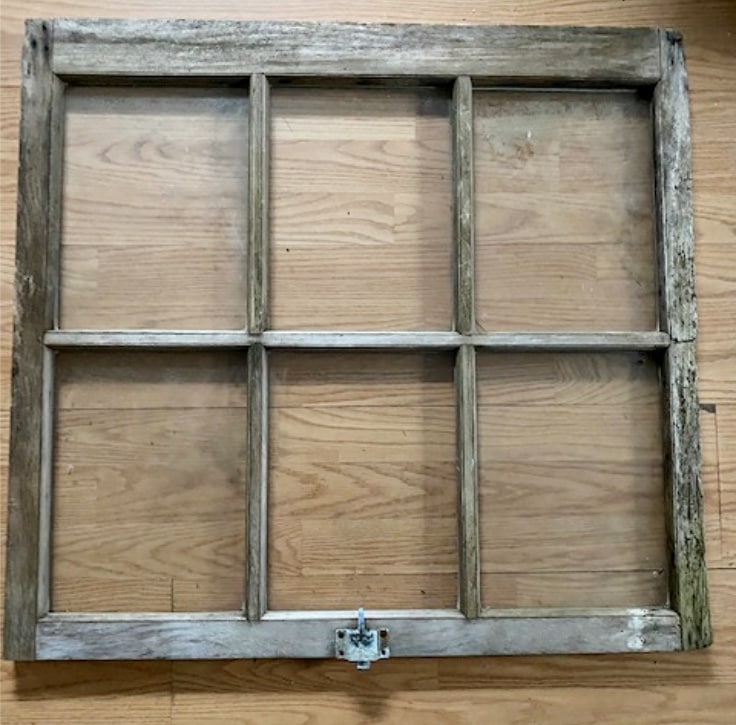 old window prior to painting shown on wood floor