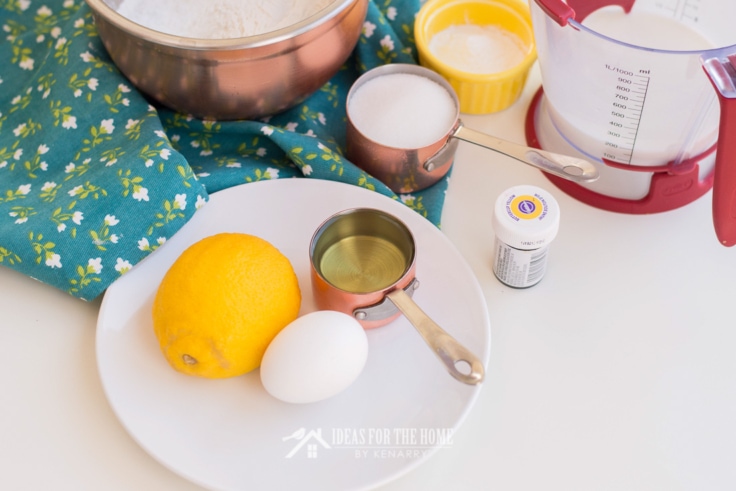 lemon muffin ingredients - lemon, egg, sugar, milk, and flour 