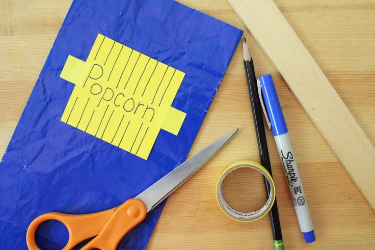 a blue paper lunch bag with a yellow 