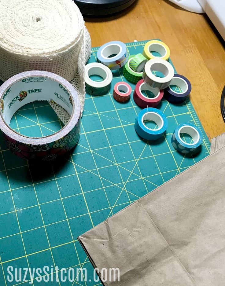 rolls of duck tape and washi tape on a craft table 
