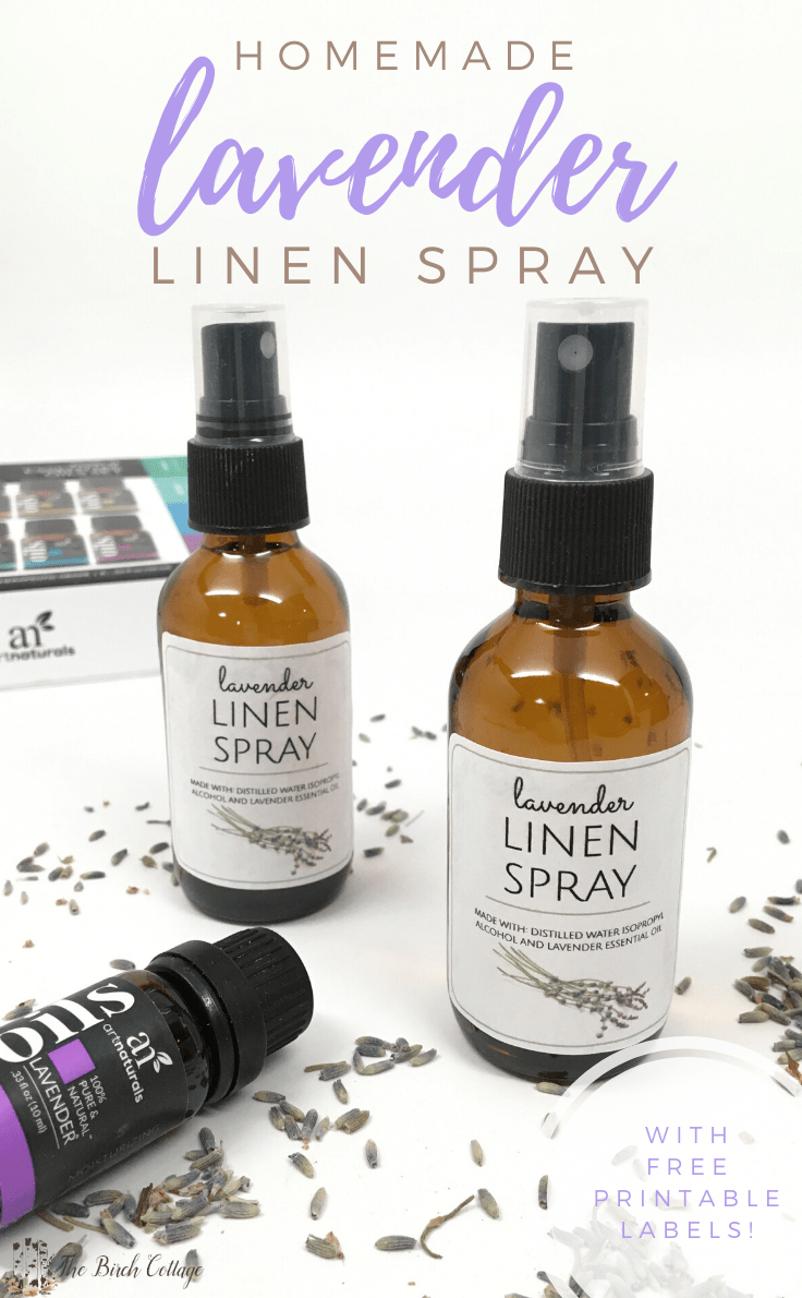 two spray bottles of lavender linen spray, bottle of lavender essential oil and lavender buds