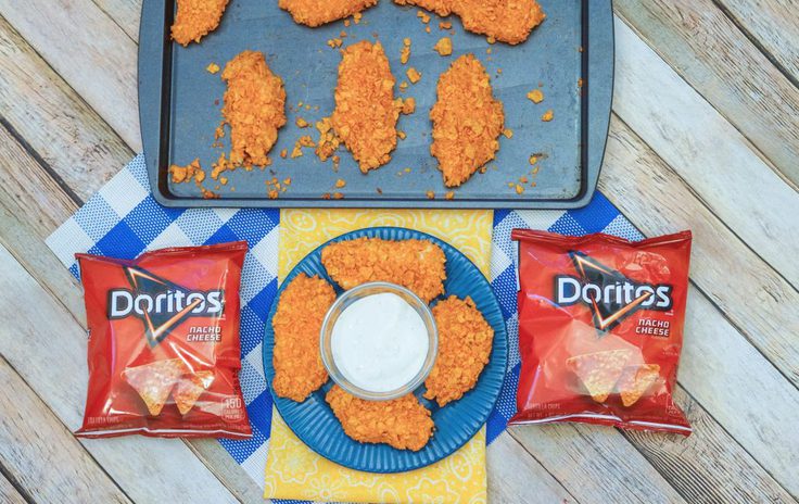 Doritos Chicken on a plate next to a few bags of Doritos 
