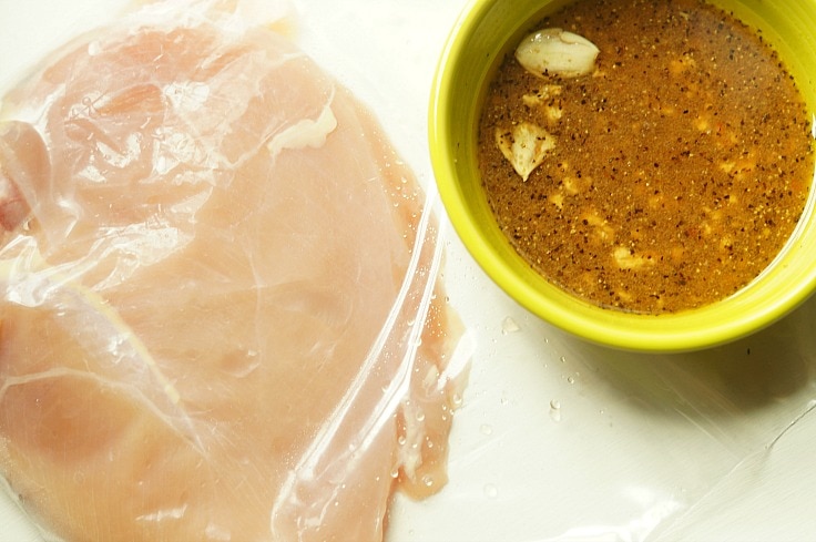 Raw chicken and a bowl of homemade marinade 