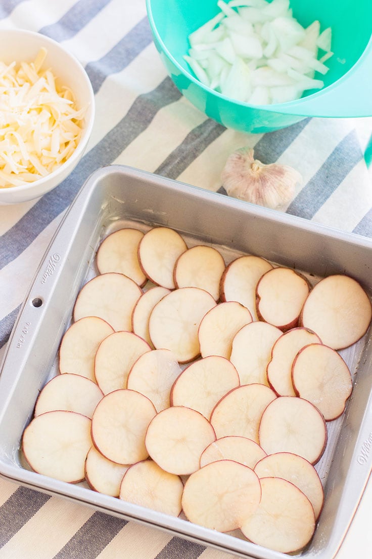 A pan of thinly-sliced potatoes that will soon become scalloped potatoes