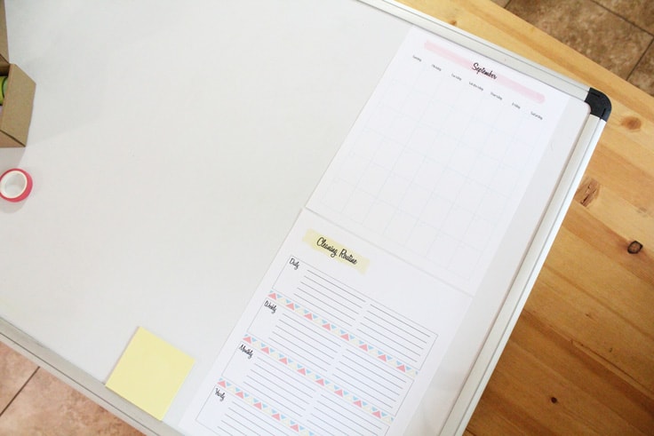 A white dry-erase board and a printed calendar 