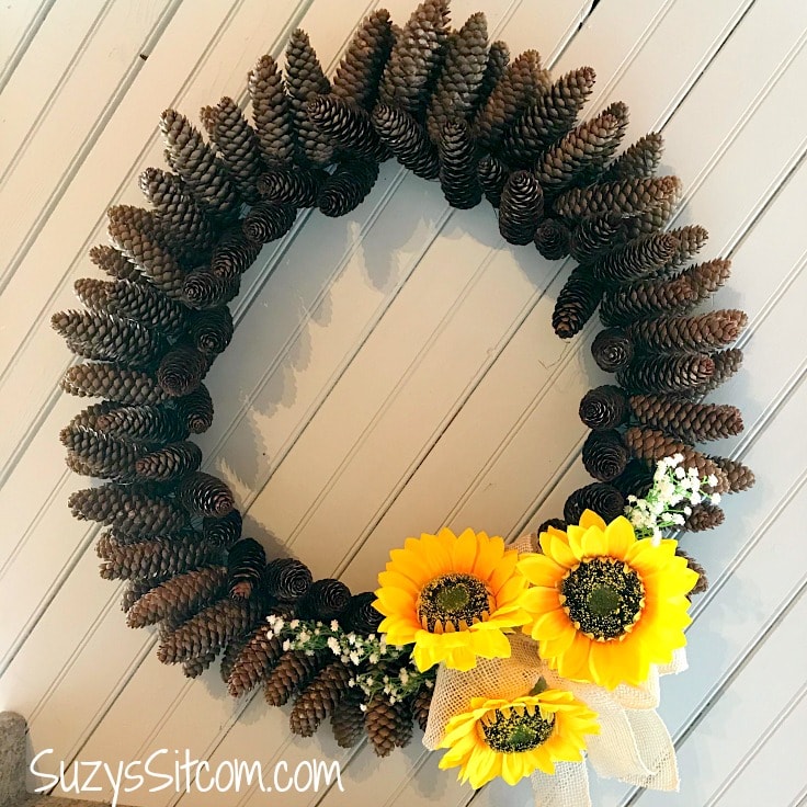 A finished pine cone wreath with sunflowers 