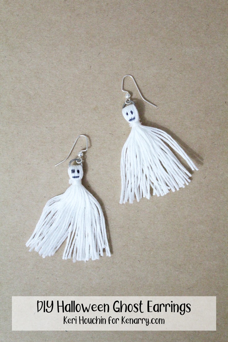 two white tassels with faces resemble ghosts made into DIY Halloween earrings