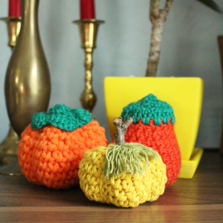 Crochet pumpkins in orange and yellow.